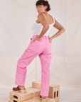 Angled back view of Carpenter Jeans in Bubblegum Pink and Cropped Cami in vintage tee off-white worn on Tiara