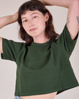 Alex is 5'8" and wearing P Cropped Burly Tee in Swamp Green