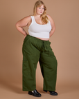Angled view of Drop Pocket Cargo Pants in Evergreen and Cropped Tank in vintage tee white