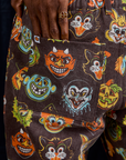 Close up of Jerrod's hand tucked into the back pocket of Work Pants in Halloween Masks