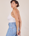Side view of Halter Top in Vintage Tee Off-White and light wash Sailor Jeans worn by Tiara