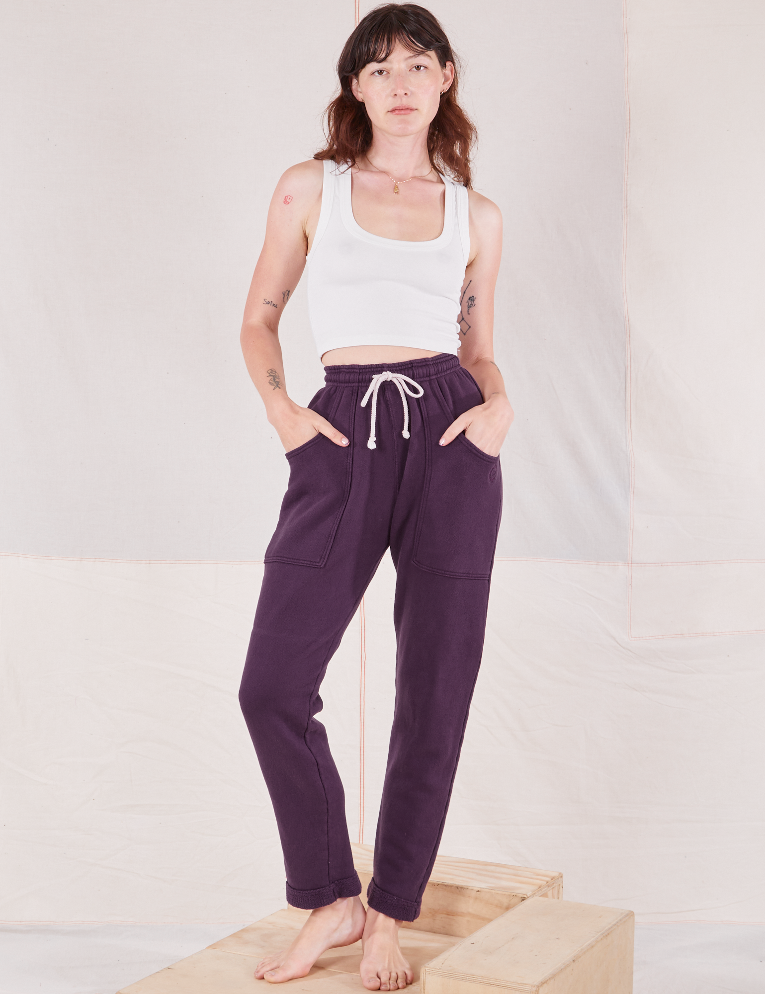Alex is 5&#39;8&quot; and wearing P Rolled Cuff Sweat Pants in Nebula Purple paired with vintage off-white Cropped Tank