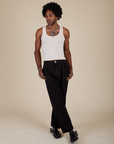 Jerrod is wearing Heavyweight Trousers in Basic Black and Vintage Tee Off-White Tank Top