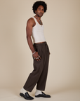 Side view of Heavyweight Trousers in Espresso Brown and Tank Top in vintage tee off-white on Jerrod