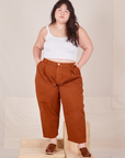 Ashley is 5'7" and wearing 1XL Petite Heavyweight Trousers in Burnt Terracotta paired with vintage off-white Cropped Cami