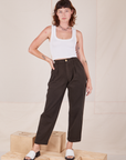 Alex is 5'8" and wearing XXS Heavyweight Trousers in Espresso Brown paired with Cropped Tank Top in vintage tee off-white