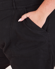 Heritage Short Sleeve Jumpsuit in Basic Black front pocket close up with Katie's hand in it.