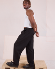 Side view of Heritage Trousers in Basic Black and Cropped Tank in vintage tee off-white on Issac