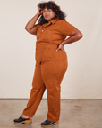 Side view of Short Sleeve Jumpsuit in Burnt Terracotta worn by Morgan