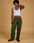 Jerrod is wearing Baggy Mid-Rise Trousers in Evergreen and vintage tee white Cropped Tank