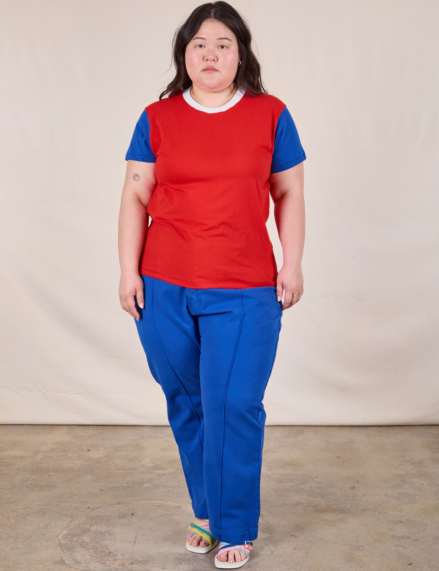 Ashley is wearing Mismatched Tee in Red & Blue and royal blue Western Pants
