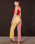 Angled back view of Western Pants in Ketchup/Mustard Stripes and mustang red Cami on Alex