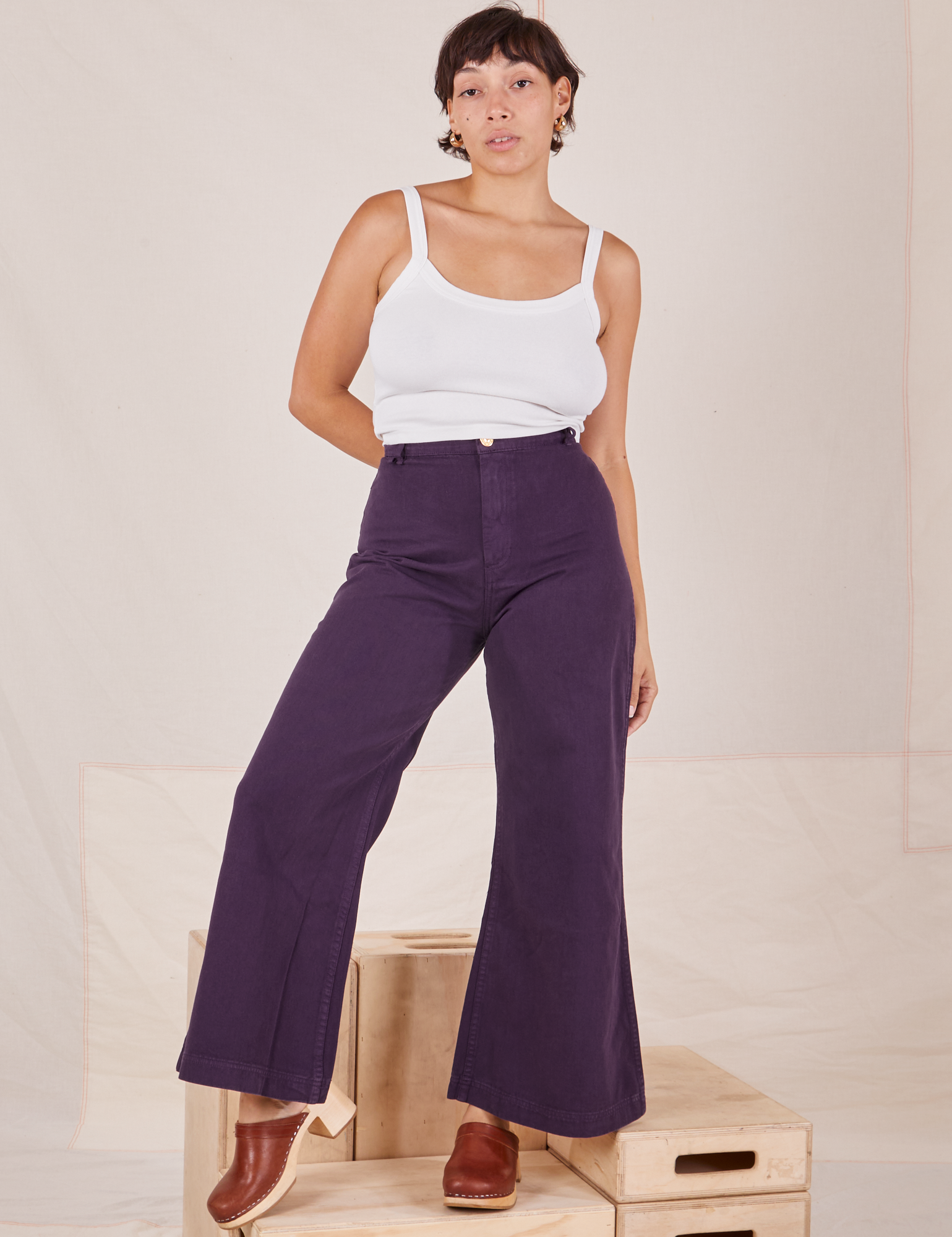 Tiara is 5&#39;4&quot; and wearing XS Bell Bottoms in Nebula Purple paired with vintage off-white Cropped Cami