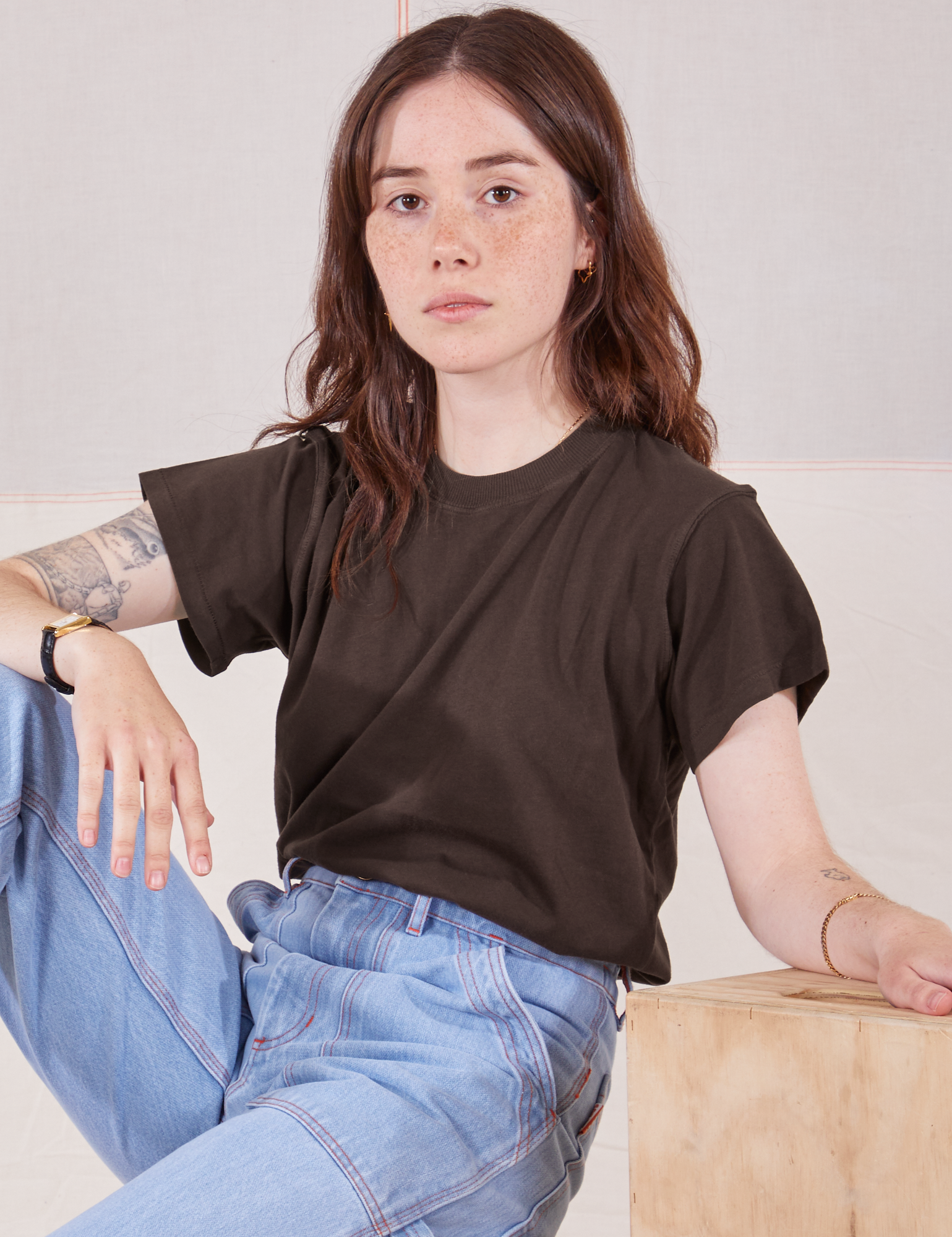 Hana is wearing Organic Vintage Tee in Espresso Brown and light wash Carpenter Jeans