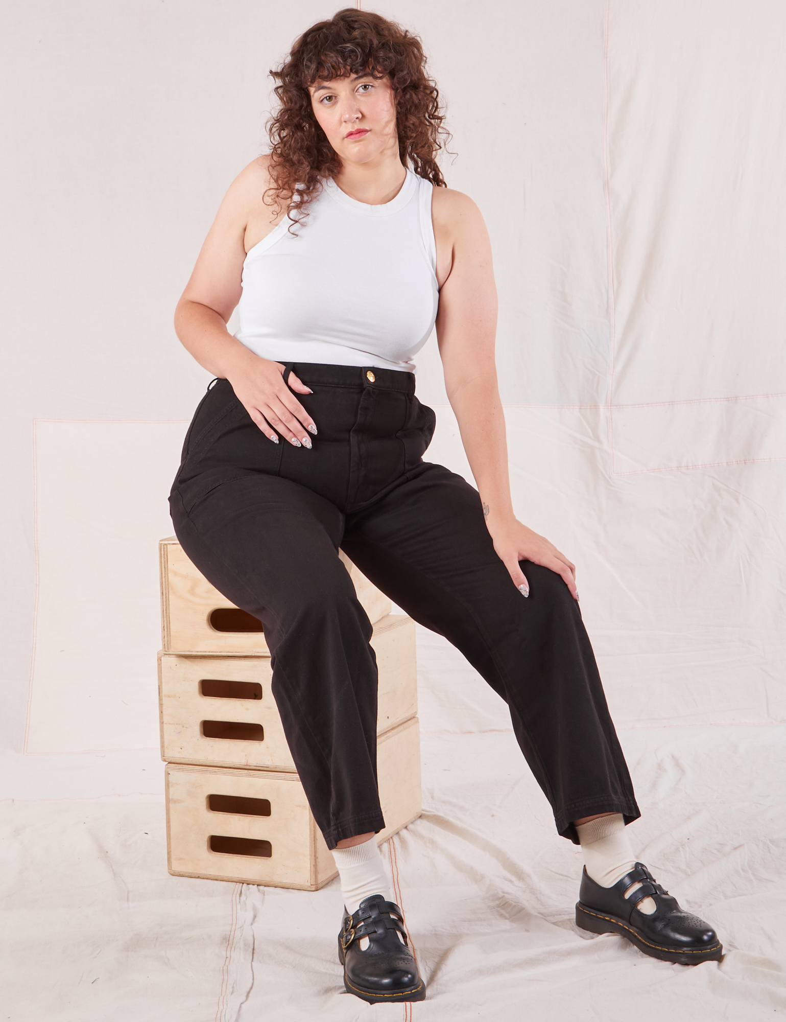 Ryan is wearing Organic Work Pants in Basic Black and Racerback Tank in vintage tee off-white