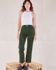 Alex is 5'8" and wearing XXS Organic Work Pants in Swamp Green paired with Racerback Tank in vintage tee off-white