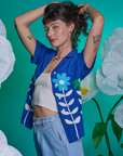 Alex is wearing Paintstamped Pantry Button-Up in Daisy