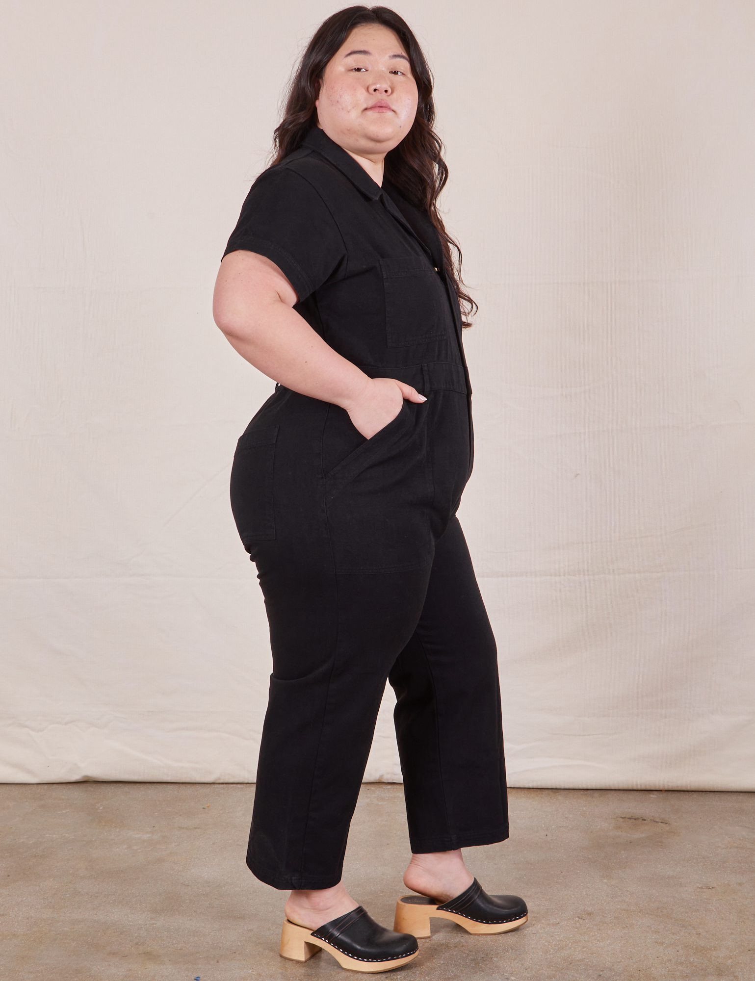 Petite Short Sleeve Jumpsuit in Basic Black side view on Ashley
