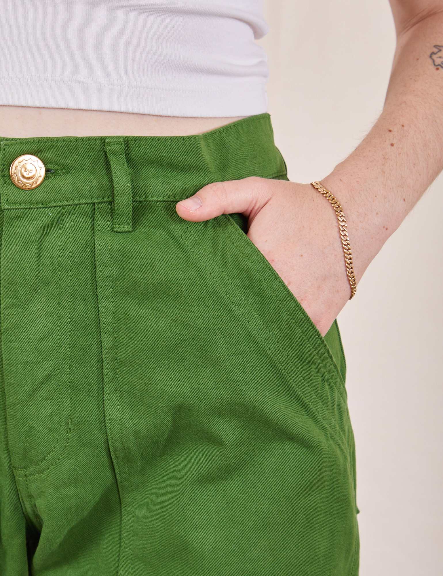 Petite Pencil Pants in Lawn Green front pocket close up. Hana has her hand in the pocket.