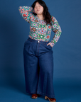 Ashley is wearing Long Sleeve Baby Tee in Quilt Print tucked into dark wash Indigo Wide Leg Trousers