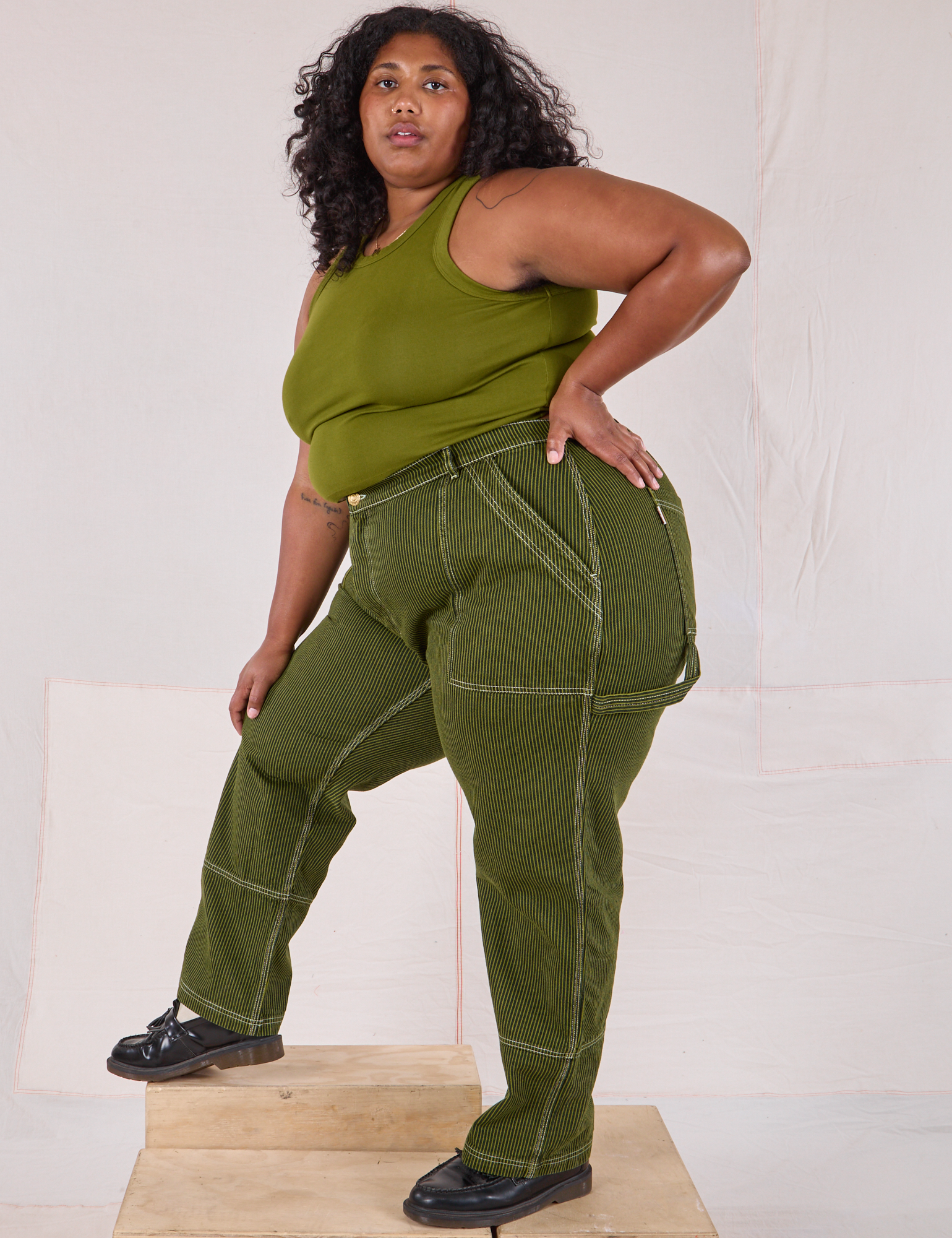 Side view of Railroad Carpenter Jeans in Summer Olive and Muscle Tee on Morgan