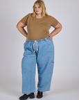 Juliet is wearing Jr. Varsity Tee in Desert Brown and light wash Denim Drop Pocket Pants
