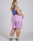 Angled back view of Longline Work Shorts in Lilac Purple on Juliet