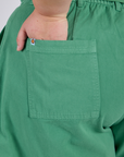 Close up of Juliet's hand in the back pocket of Longline Work Shorts in Seafoam Green