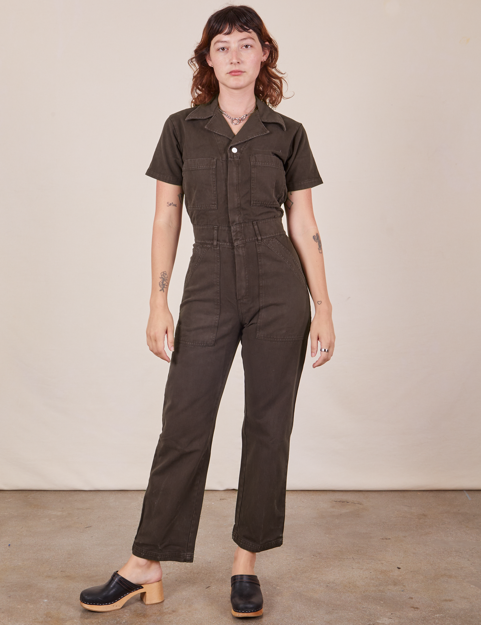Alex is 5'8" and wearing XS Short Sleeve Jumpsuit in Espresso Brown