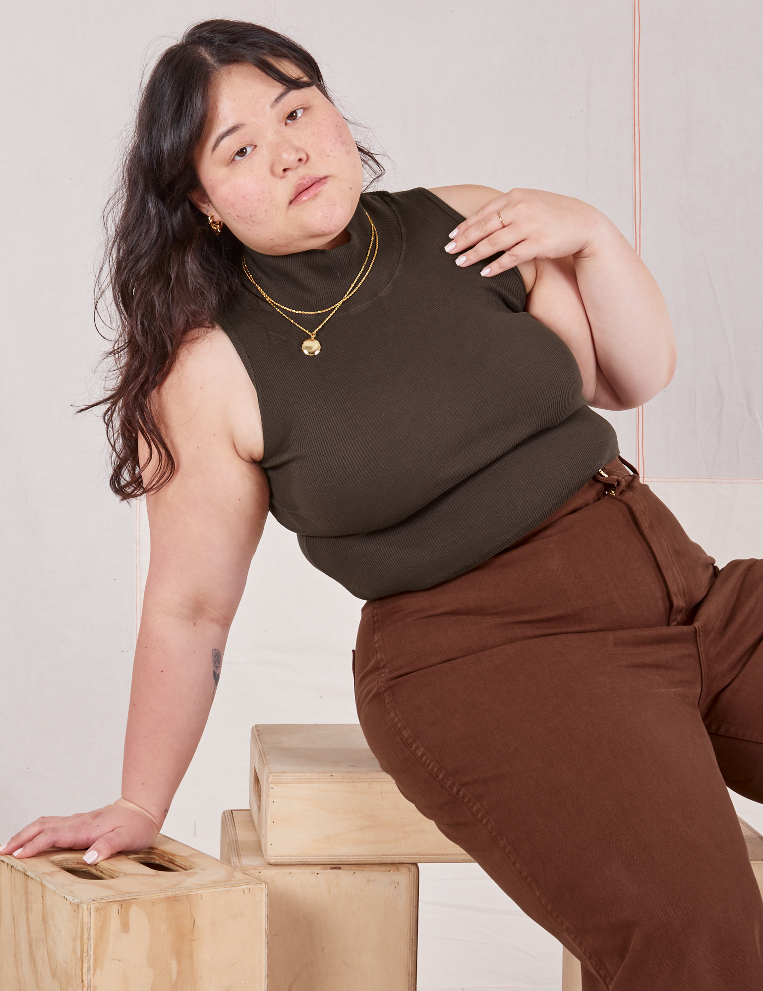 Ashley is wearing Sleeveless Essential Turtleneck in Espresso Brown and fudgesicle brown Bell Bottoms