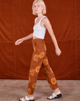 Side view of Paintstamped Work Pants in Orange and Cropped Tank in Vintage Tee Off-White on Madeline