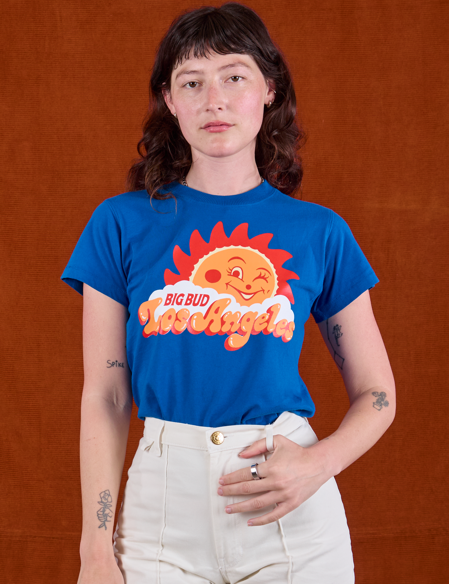 Alex is wearing Sunny Los Angeles Tourist Tee tucked into vintage tee off-white Western Pants
