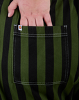 Close up of Juliet's hand in the back pocket of Longline Work Shorts in Evergreen