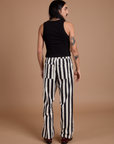 Back view of Black Stripe Work Pants in White and black Cropped Tank on Anthony