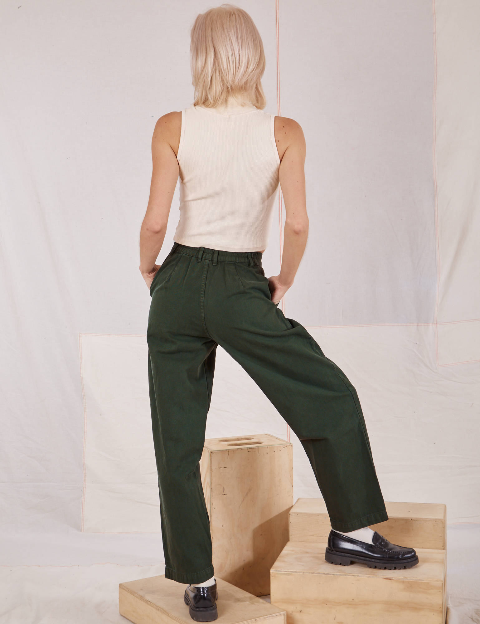 Back view of Heavyweight Trousers in Swamp Green and vintage tee off-white Sleeveless Turtleneck on Madeline