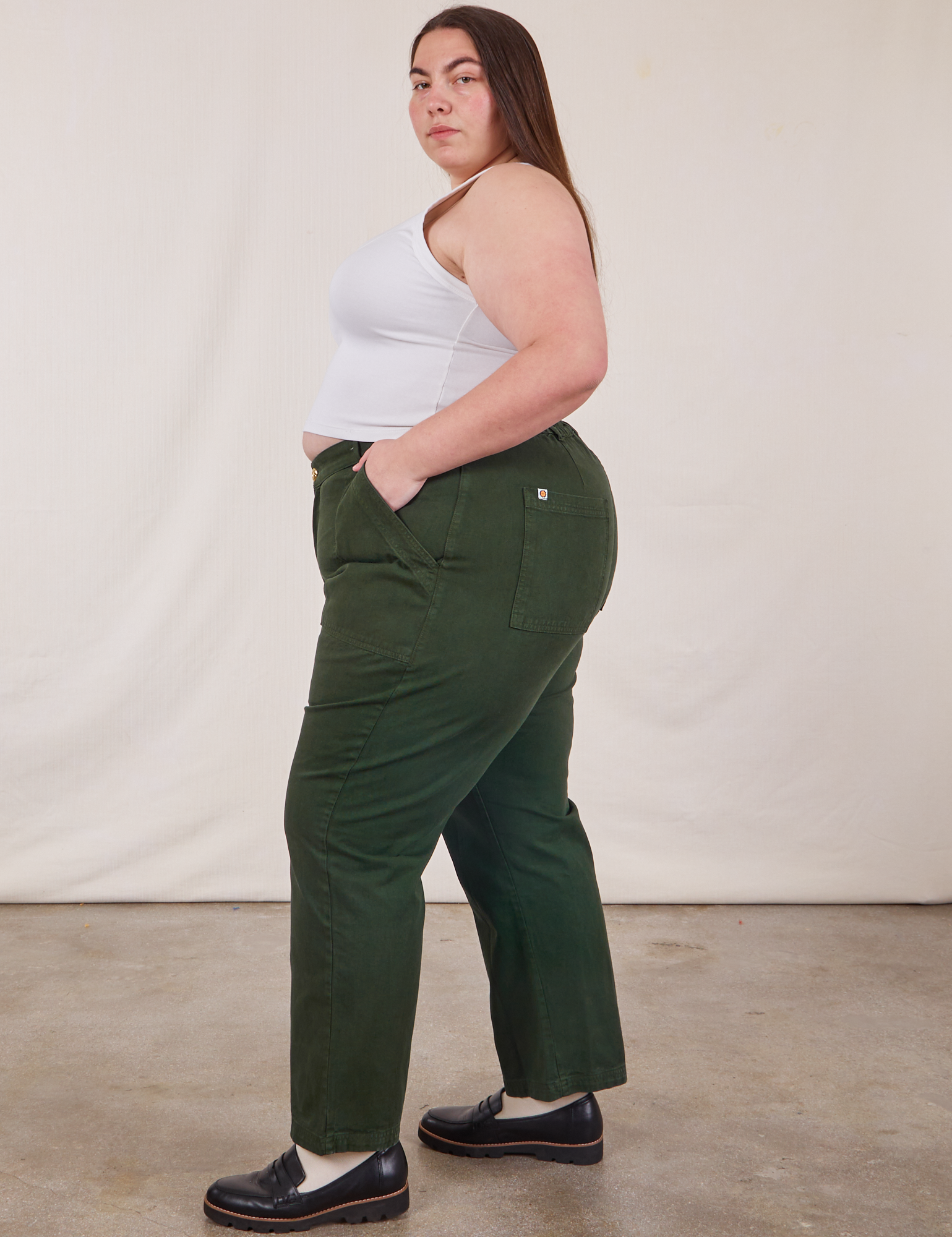 Side view of Work Pants in Swamp Green and Cropped Tank Top in vintage tee off-white on Marielena