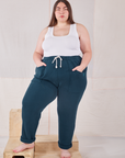 Marielena is 5'8" and wearing 1XL Rolled Cuff Sweat Pants in Lagoon paired with Cropped Tank in vintage tee off-white