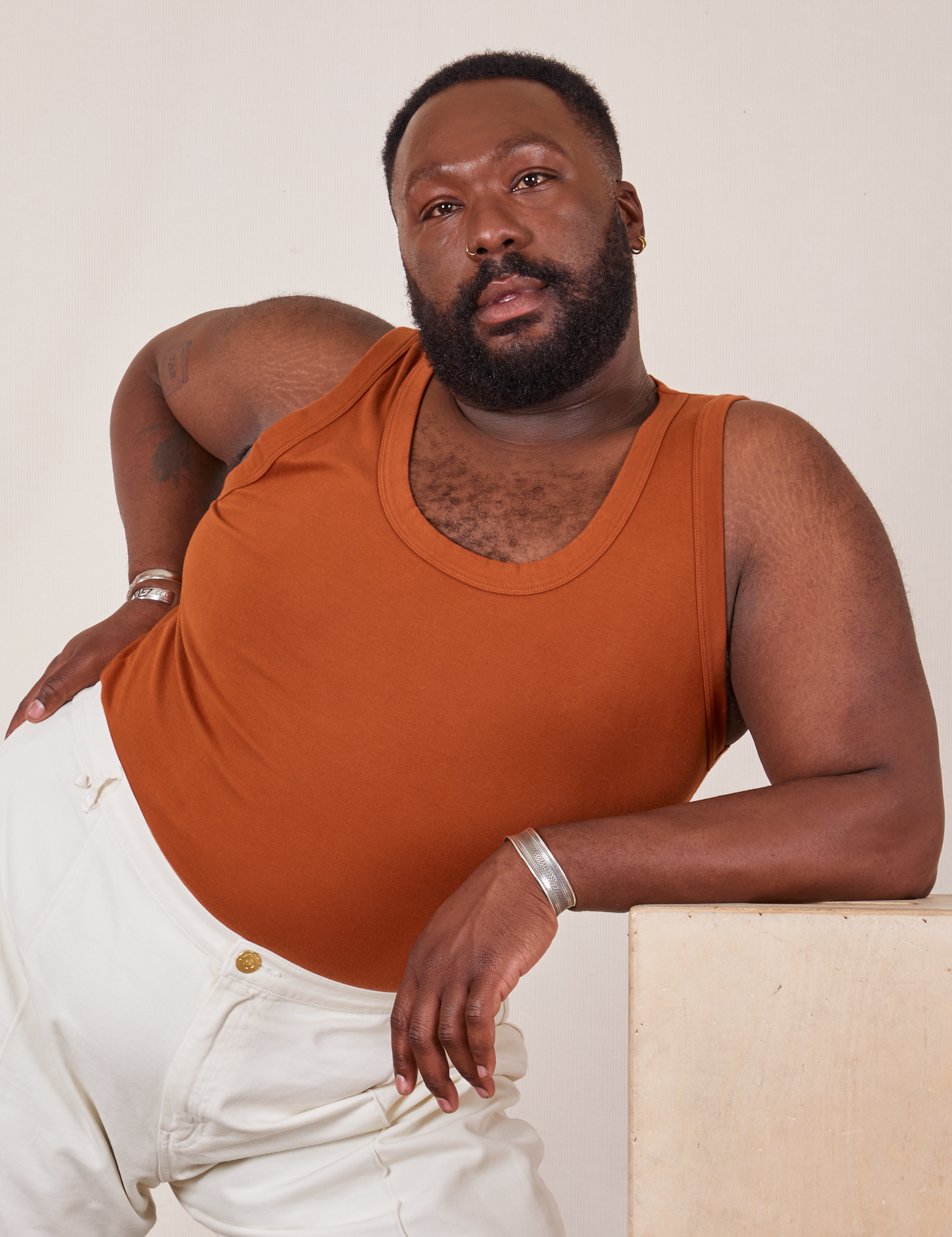 Elijah is wearing Tank Top in Burnt Terracotta
