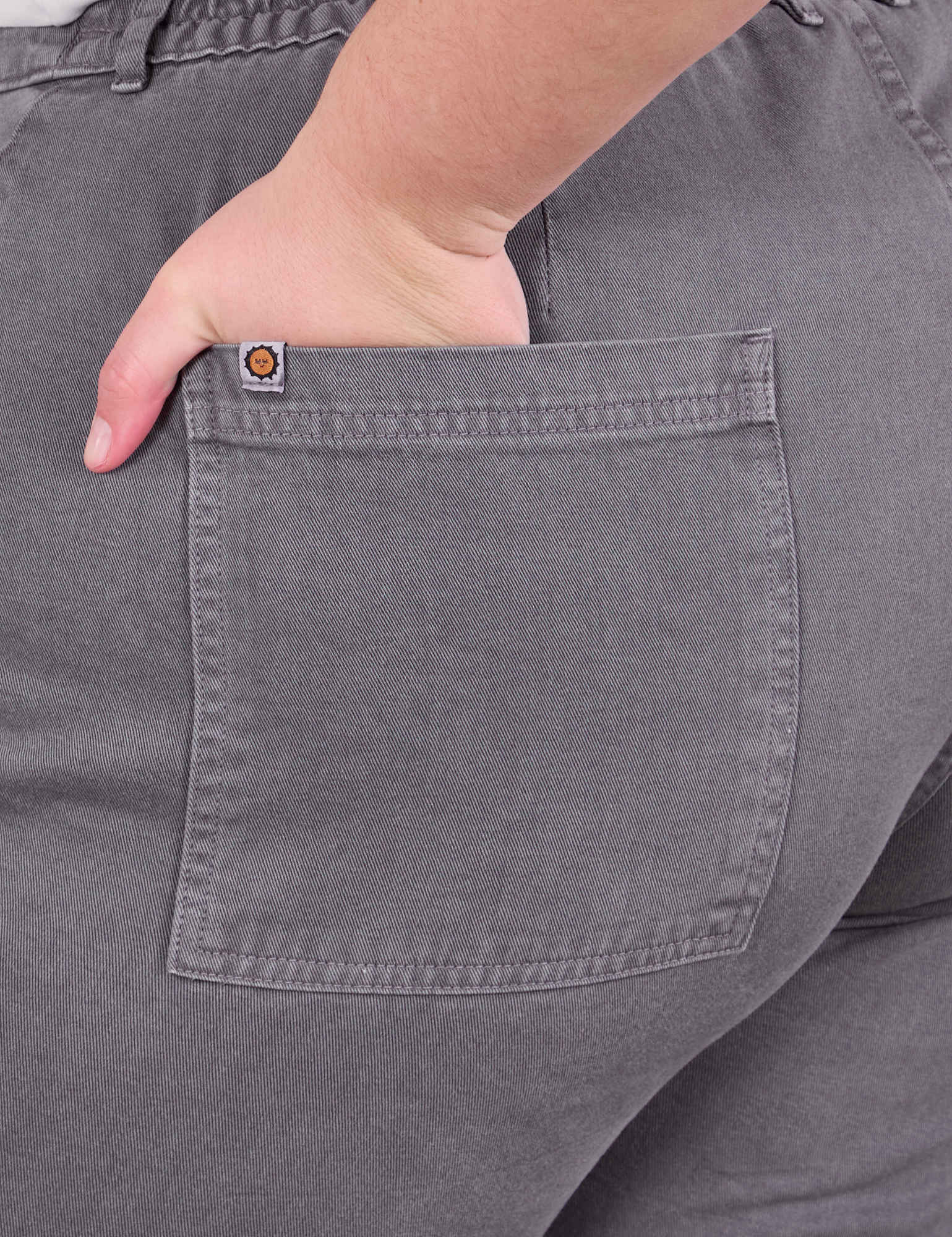 Close up of Marielena's hand in the back pocket of Work Pants in Washed Grey
