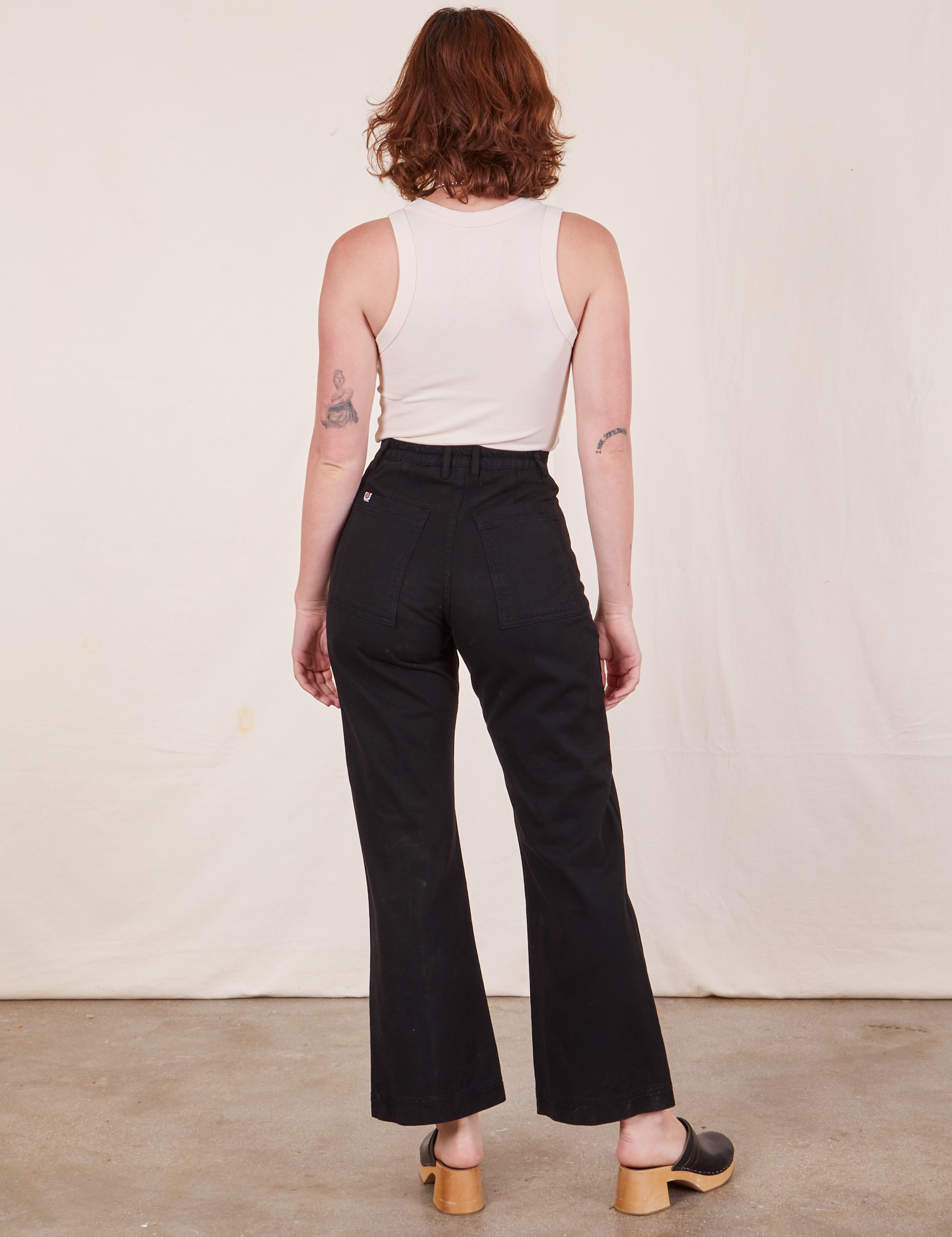 Back view of Western Pants in Basic Black and Tank Top in  vintage Tee off-white worn by Alex