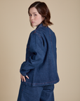 Angled back view of Indigo Denim Work Jacket in Dark Wash on Hana