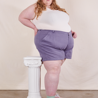 Angled view of Classic Work Shorts in Faded Grape and vintage off-white Tank Top worn by Catie
