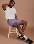 Isaac is wearing Classic Work Shorts in Faded Grape and Organic Vintage Tee in Vintage Tee Off-White