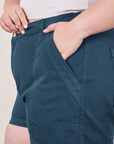 Classic Work Shorts in Lagoon front pocket close up. Ashley has her hand in the pocket.