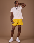 Jerrod is 6'3" and wearing M Classic Work Shorts in Sunshine Yellow paired with Organic Vintage Tee in Vintage Off White