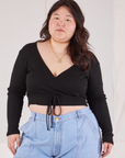 Ashley is 5'7" and wearing size 4 Wrap Top in Basic Black