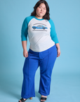 Ashley is wearing Taxi Raglan Tee in San Francisco and royal blue Western Pants