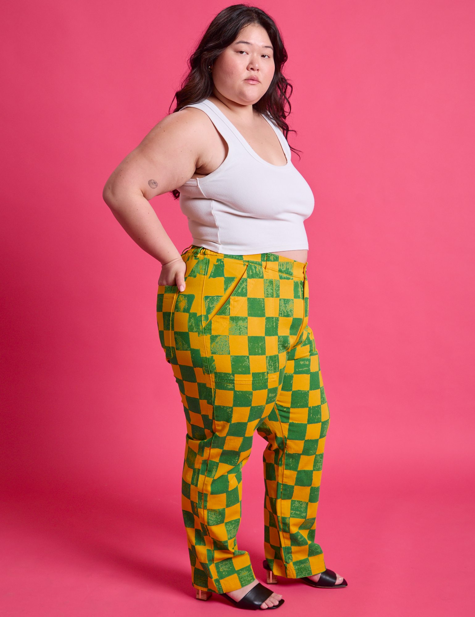 Side view of Checkerboard Work Pants in Green/Yellow and Cropped Tank in Vintage Tee White on Ashley