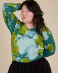 Ashley is wearing Long Sleeve Baby Tee in Green Magic Waters