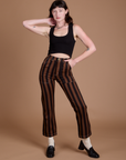 Alex is 5’8” and wearing XXS Black Stripe Work Pants in Fudgesicle Brown paired with black Cropped Tank